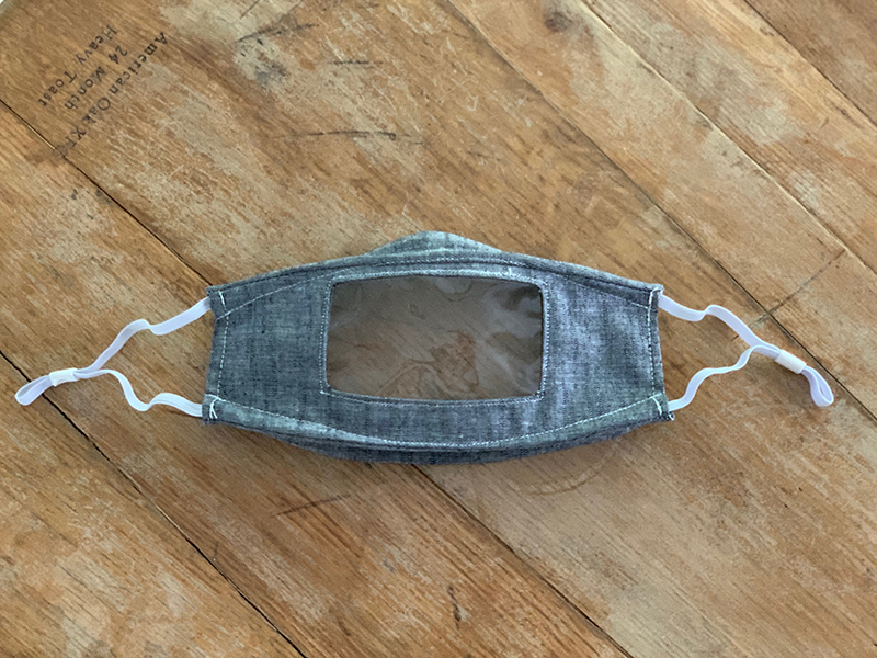 Made from 100% cotton with a clear vinyl window, the Read My Lips Mask offers a comfortable, snug-fitting, adjustable design. Sewing Angels volunteer Cristina Phaneuf of Bumbleroot Design adapted her favorite mask pattern to create the design. She m…
